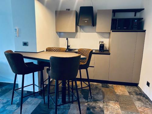 a kitchen with a wooden table and chairs at La casa di SELLY 3 - A 10 Metrì Dal Mare- in Bergeggi