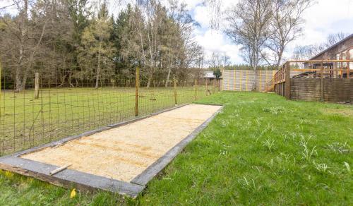 a garden with a fence and a field at Auberge de la Fagne in Malmedy