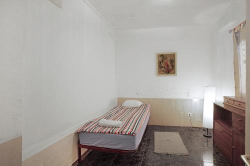 ein kleines Zimmer mit einem Bett in der Ecke in der Unterkunft Casa de Jordan in Castillo del Romeral