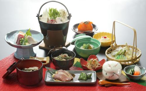 a table with many different dishes of food on it at バートンホテル Barton Hotel in Shinano