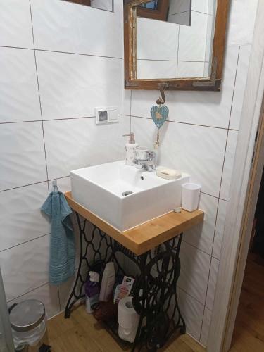 a bathroom with a white sink and a mirror at Domek z kominkiem, Ukta 63, Mazury, in Ruciane-Nida