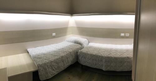 a bedroom with two beds and a window at La Suite del Mare in Calambrone