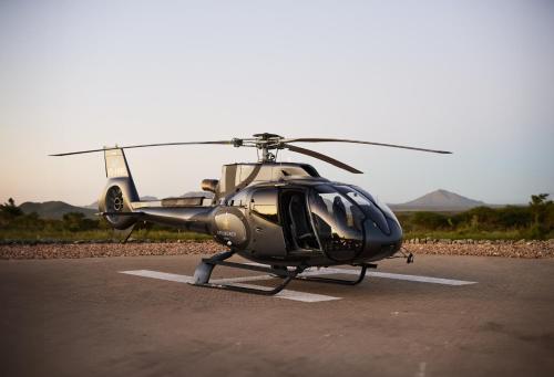 a helicopter is parked in a parking lot at Gmundner Lodge in Windhoek