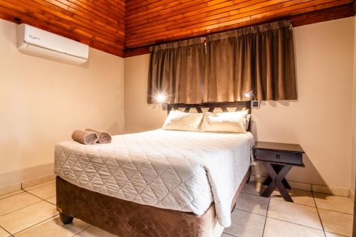 a bedroom with a large bed with a wooden ceiling at ATKV Klein-Kariba in Bela-Bela