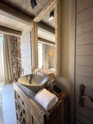 a bathroom with a sink and a mirror at Selene Luxury Rooms in Sinevrón