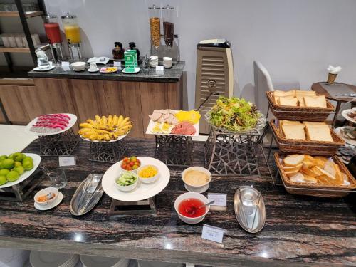 a buffet with different types of food on a counter at Thanh Long Hotel - Tra Khuc in Ho Chi Minh City