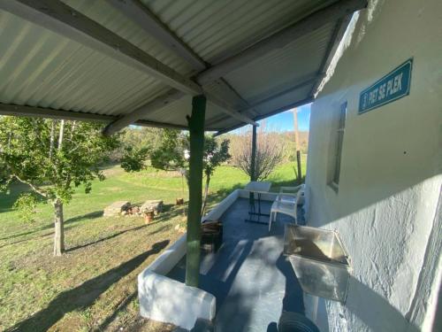 a patio with awning on the side of a house at Berge toe - Spanspek se plek Farmstay in Bonnievale