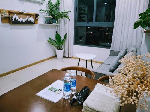 a living room with a table and a couch at Bcons Garden Luxury Aparment in Dĩ An