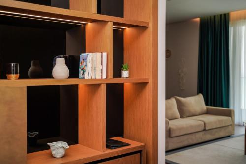 a book shelf with books and a couch in a room at Supreme Hotel in Golem
