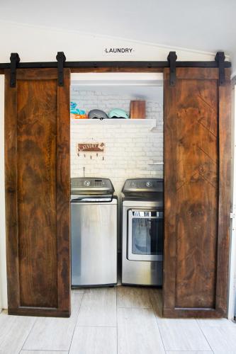 a kitchen with two washers and a stove at Brick Enclave with Mini Golf & SPA, 5mins to beach in Naples