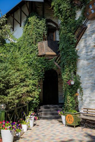 a house with plants growing on the side of it at Metelitsa Hotel in Karagandy