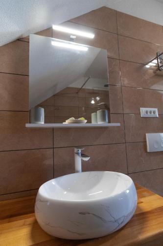 a bathroom with a white sink and a mirror at Taverna & Rooms in Sutivan