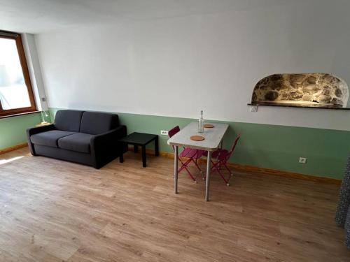 a living room with a couch and a table at Studio les Rosiers in Quillan