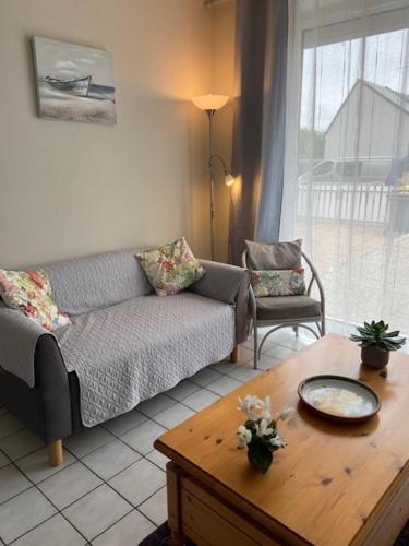 un salon avec un canapé et une table basse dans l'établissement La Marée, à Portbail