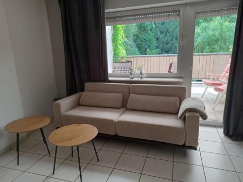a living room with a couch and two tables at Apartment Landgericht MG in Mönchengladbach