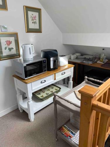 a kitchen with a microwave on a table at Helens Haven First floor apartment via stairs in Preston