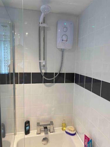 a bathroom with a shower and a sink at Helens Haven First floor apartment via stairs in Preston