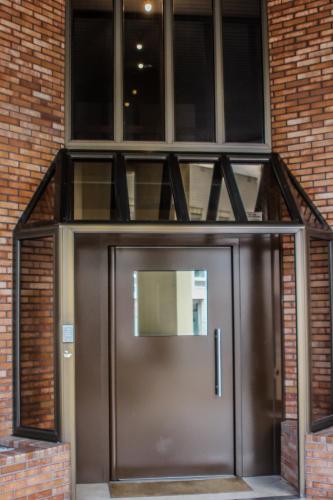 a metal door in front of a brick building at At home in Clermont, Place de Jaude in Clermont-Ferrand