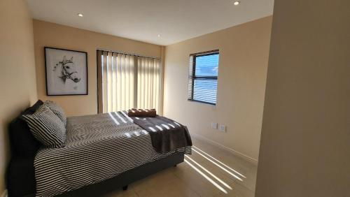 a bedroom with a bed and a window at Doves nest in Velddrif