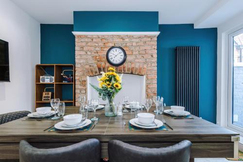a dining room with a table and a fireplace at Serene & Contemporary Hoole House in Chester