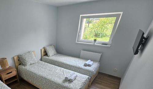 a small room with two chairs and a window at Apartament Wojska Polskiego 45 in Wadowice
