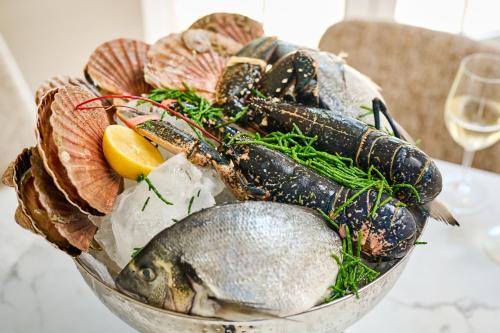 a bowl of food with fish and other foods at Milford Hall Salisbury in Salisbury
