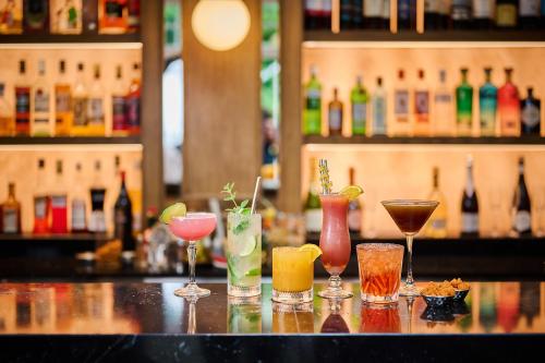 a group of different cocktails sitting on a bar at Milford Hall Salisbury in Salisbury