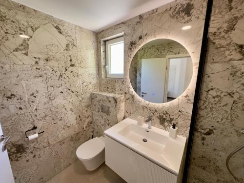 a bathroom with a white sink and a mirror at Villa Jolanda Beachside Residence in Orebić