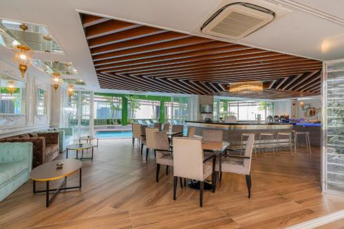 a dining room with tables and chairs and a bar at Meliá Kuala Lumpur in Kuala Lumpur