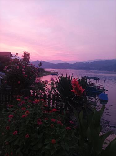 a view of a body of water with flowers at Dina apartman Jablaničko jezero in Konjic