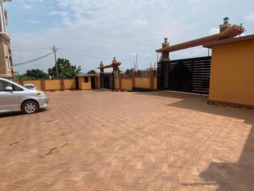 a car parked in front of a house with a driveway at Cozy 1 BR APT in Kampala on Mutungo Hill in Kampala