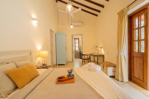 a living room with a bed and a table at ELIVAAS 4 BHK with Pvt Pool near Baga - Celest in Old Goa