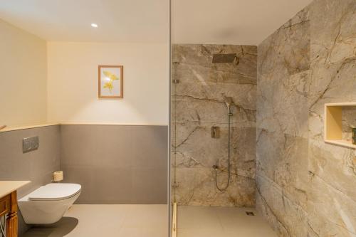 a bathroom with a shower and a toilet at ELIVAAS 4 BHK with Pvt Pool near Baga - Celest in Old Goa