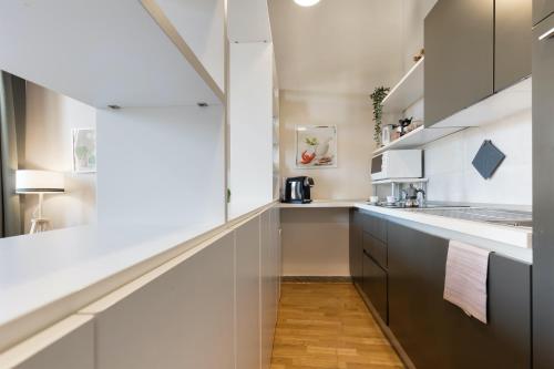 a kitchen with white walls and a long counter at Rome as you feel - Grotta Pinta apartments in Rome