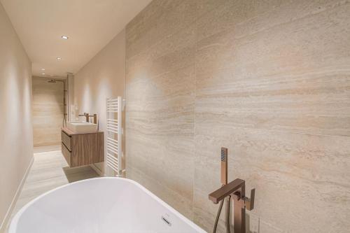 une salle de bain avec une baignoire et un lavabo dans l'établissement Appartement spacieux et lumineux pour 8, Lyon 1er, à Lyon