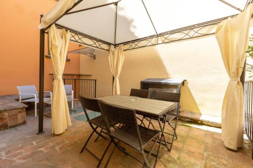 a dining room with a table and chairs under a tent at BolognaRoomscom - Frassinago Deluxe in Bologna