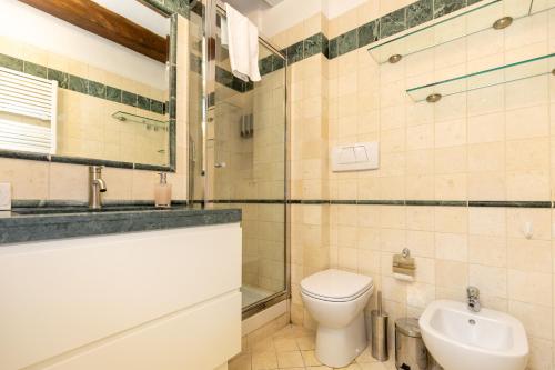 a bathroom with a toilet and a sink at BolognaRoomscom - Frassinago Deluxe in Bologna