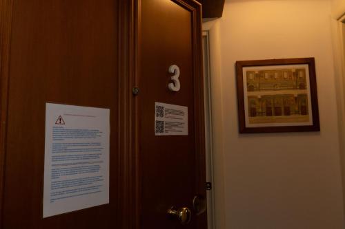 a door with a sign on it next to it at BolognaRoomscom - Frassinago Deluxe in Bologna