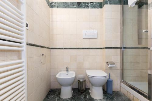 a bathroom with a toilet and a shower at BolognaRoomscom - Frassinago Deluxe in Bologna