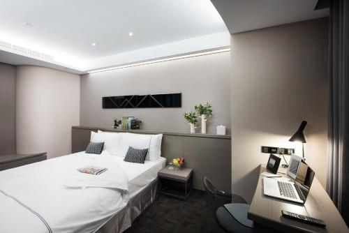 Voodi või voodid majutusasutuse Hotel Reve Taichung toas