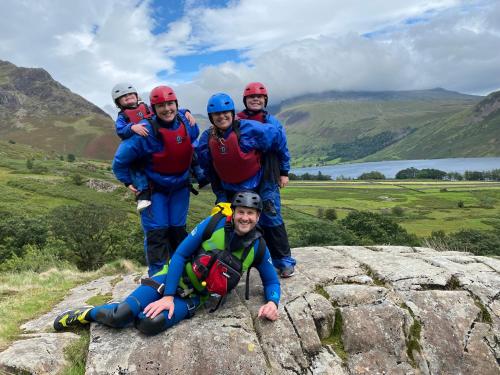 a group of people standing on top of a rock at Cosy Glamping In the Eskdale Valley - Studio Lodges and Mega Pods in Eskdale