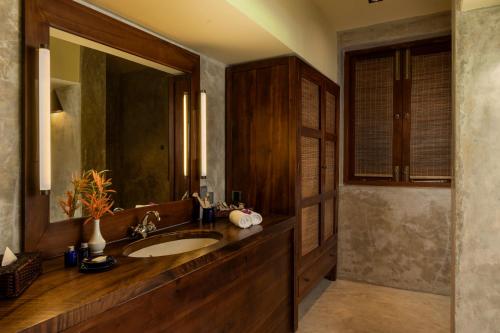 a bathroom with a sink and a mirror at Jetwing Kurulubedda - Adults Only in Galle