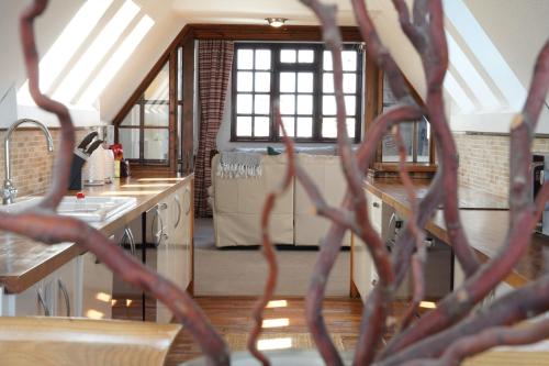 a kitchen with a view of a kitchen with a roof at Spacious 4-Bedroom Penthouse Sleeps 8 - Great City View and Free Parking in Portsmouth