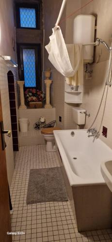a bathroom with a tub and a sink and a toilet at Burg Hermannstein - Monks Room in Wetzlar