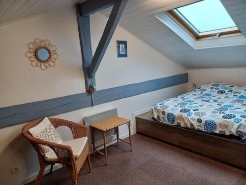 a bedroom with a bed and a table and a chair at Infinity View Bidart in Bidart