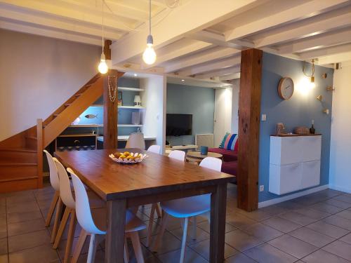 a kitchen and dining room with a wooden table and chairs at Infinity View Bidart in Bidart