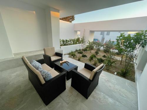 a living room with two chairs and a table at Casa Suites Mykonos in Agios Stefanos