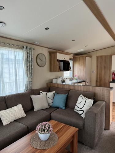a living room with a couch and a table at Hot tub retreat at Tattershall Lakes in Tattershall