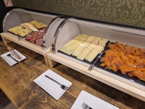 a tray of cheese and other foods on a table at Beelodge Hotel Blois Centre in Blois