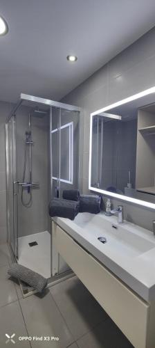 a bathroom with a large sink and a shower at Sunrise Apartamentos in San Bartolomé